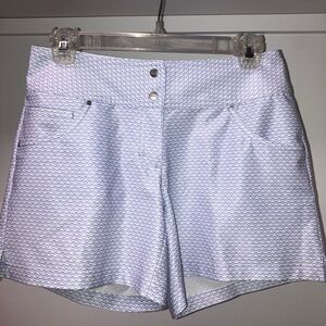 Slazenger women’s golf shorts.  White background with light purple design.